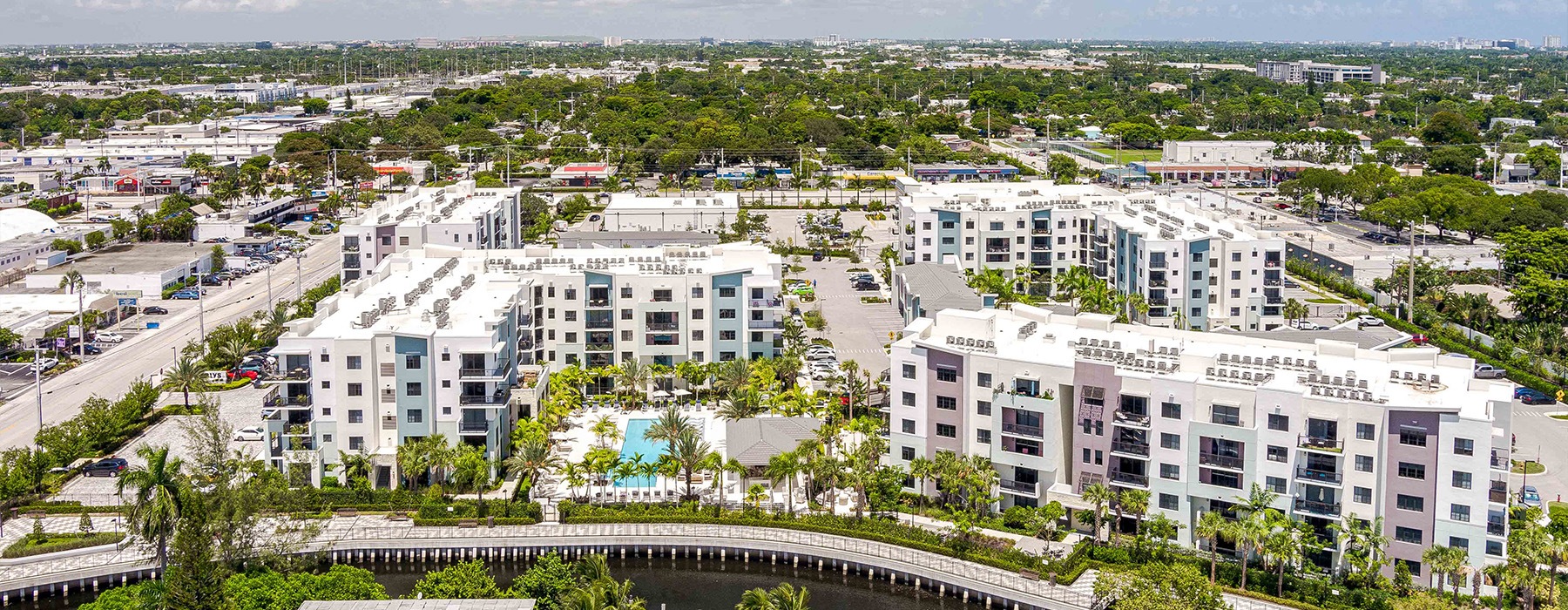 aerial shot of a building on a riverwalk